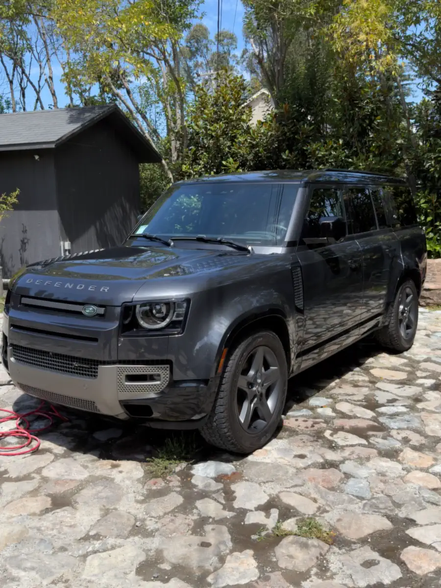 After: the same SUV with clean, glossy paint and clean wheels