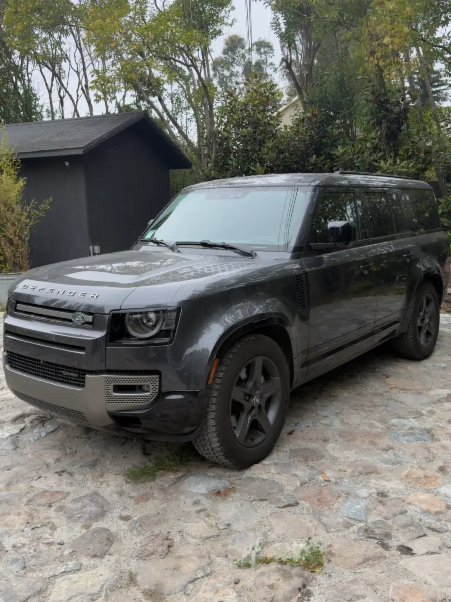 Before: grey SUV with dull, dusty paint, parked on a stone driveway