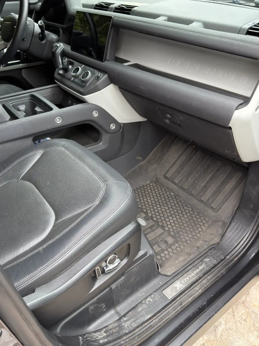 Before: passenger footwell with a dusty floor mat and scuffed sill plate