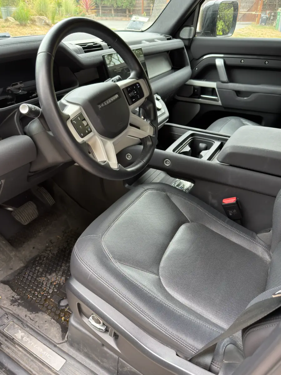 Before: driver’s seat and footwell, with a dirty, wet floor mat and dust on the leather